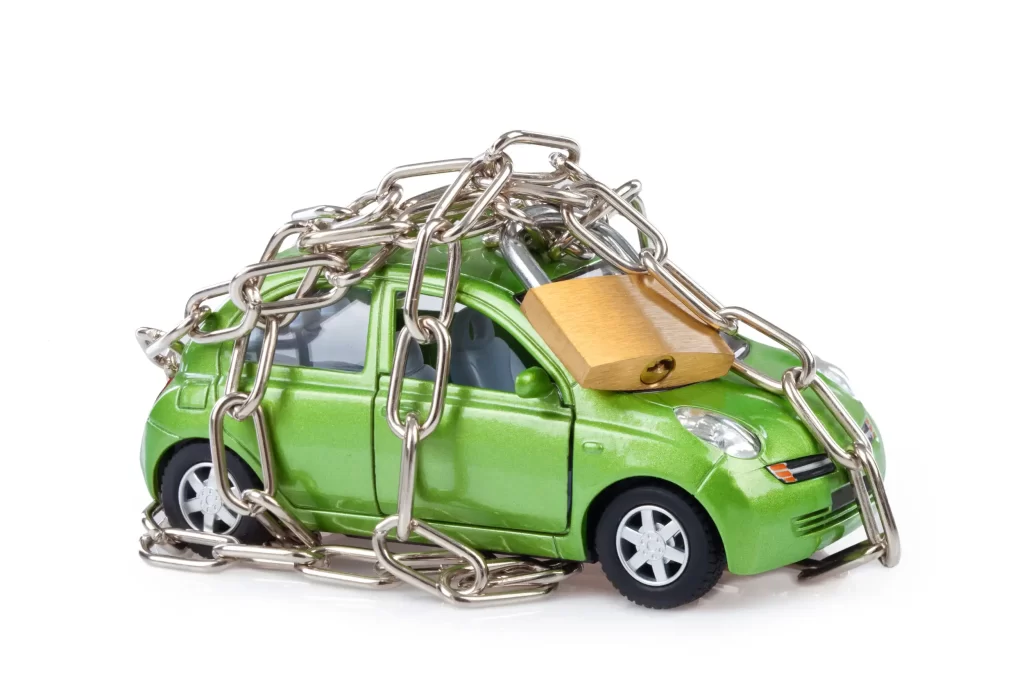 A presentation of a locked out car with padlock and chains.