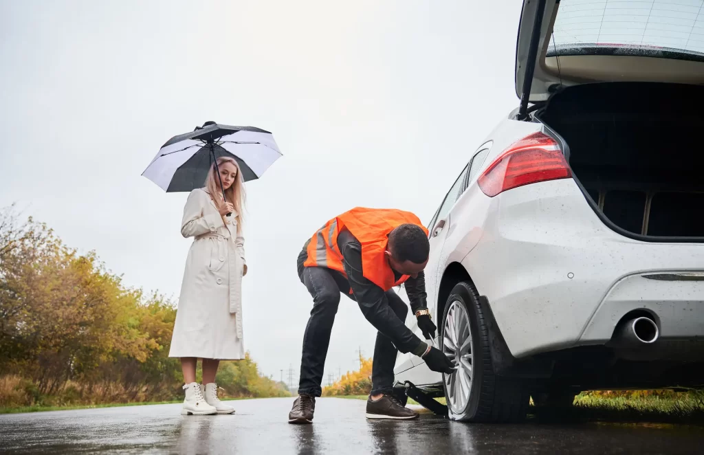 Tow truck providing roadside assistance on a busy highway