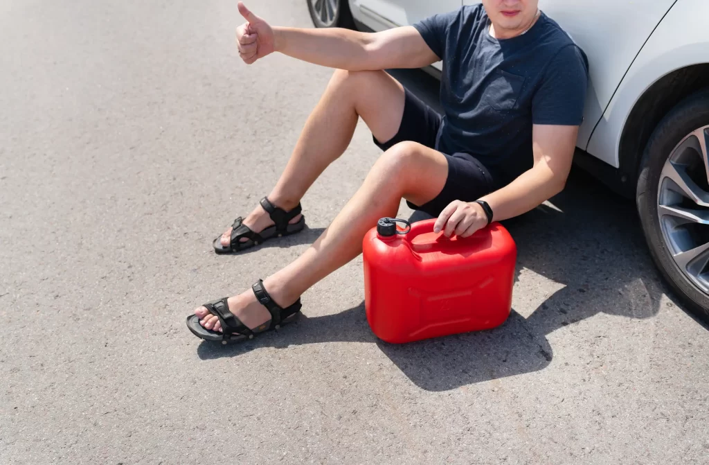 A man ran out of gas lying in the road waiting for the roadside assistance.