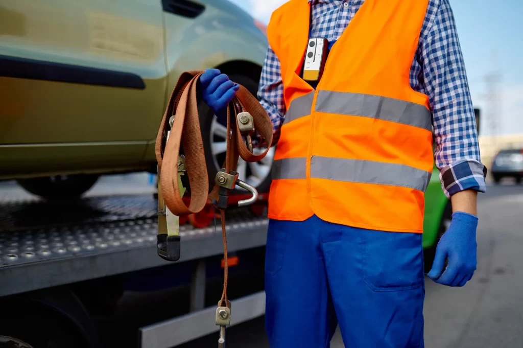 A towing service crew carrying a winch out cable for the car.