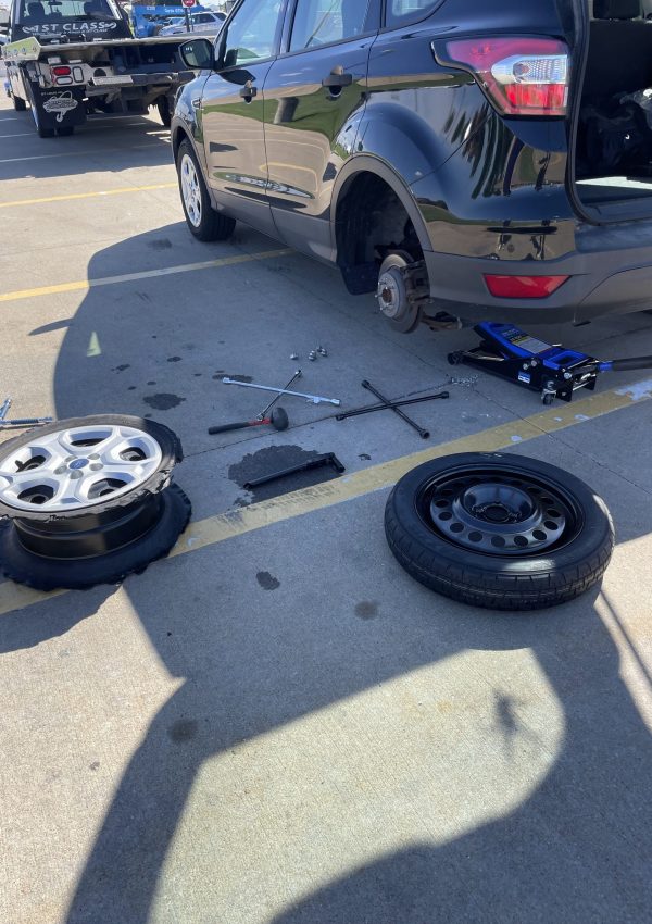 An image of a car performing to change its tires.