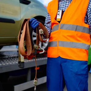A towing service crew carrying a winch out cable for the car.