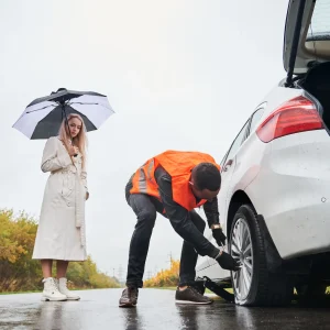 Tow truck providing roadside assistance on a busy highway