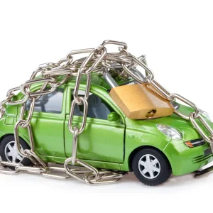 A presentation of a locked out car with padlock and chains.